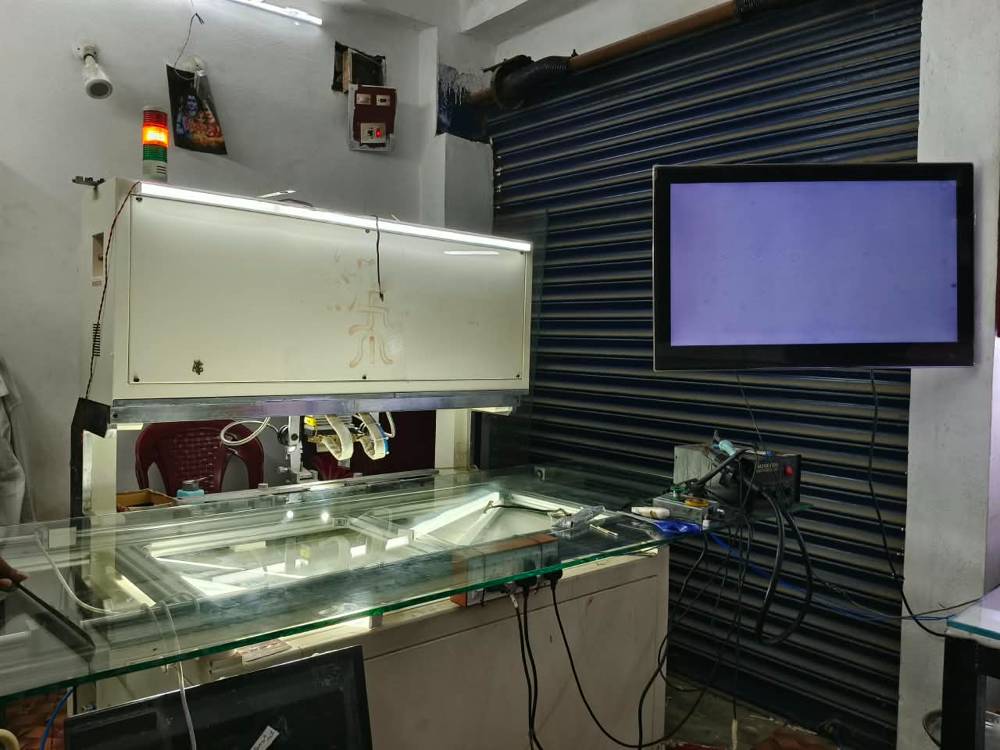 Bonding machine with lit glass work table, soldering station and monitor